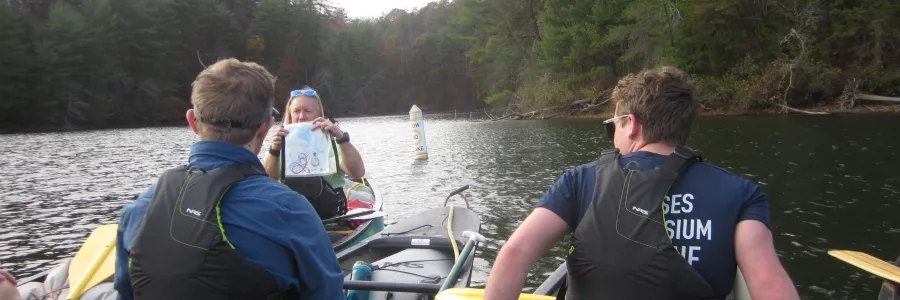 canoers listening to a map lesson on the water