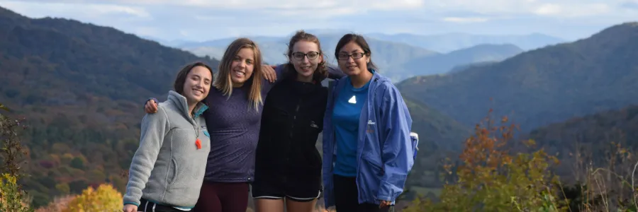 Women standing in front of a mountain