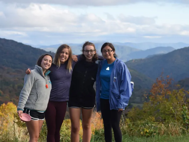 Women standing in front of a mountain